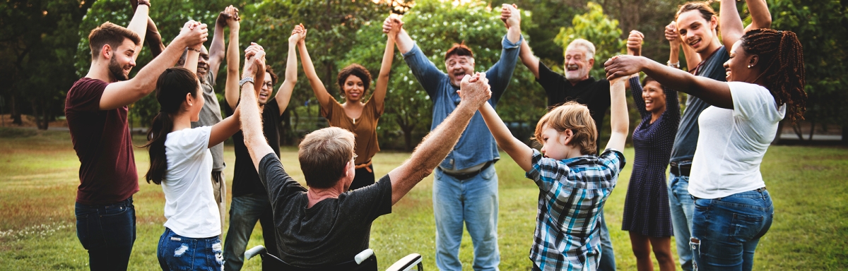 Group of people holding hand together in the park