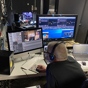 Person working at desk with multiple monitors