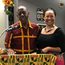 Professor Walter Turner behind microphone with student