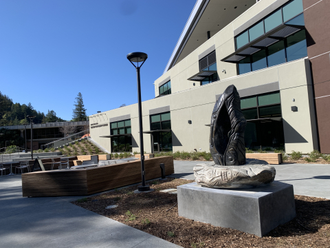 Sculpture, Burning Flame by Harkin Lucero, Jr. in front of Center for Student Success