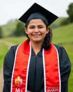 Student in black graduation regalia and red stole